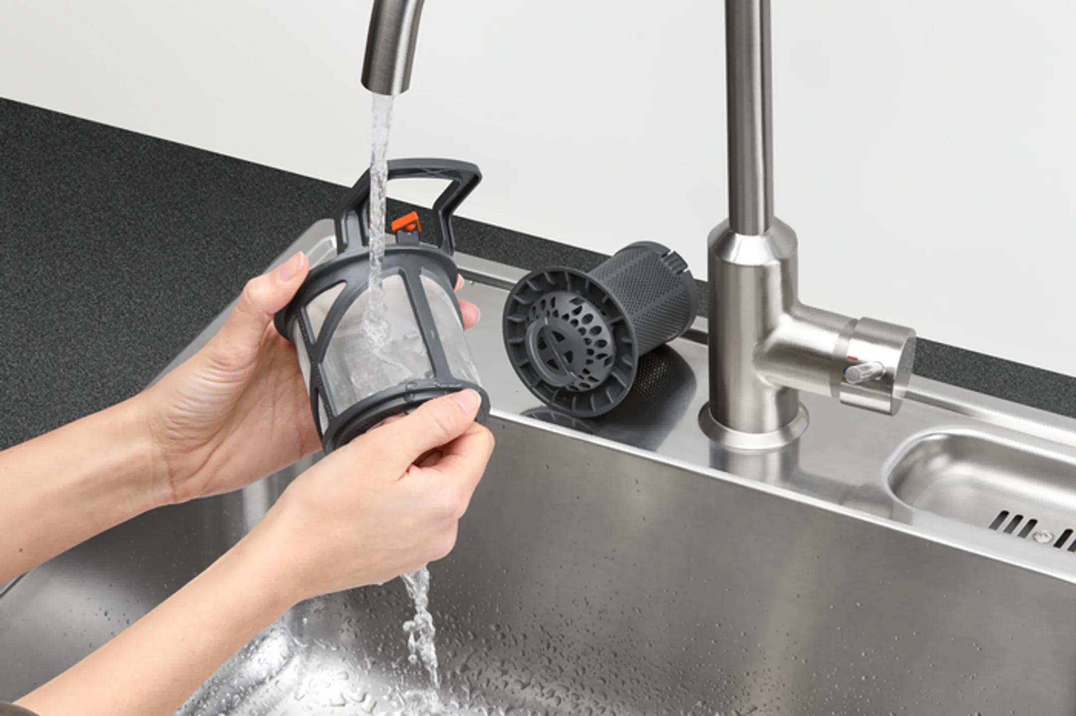 How to clean a dishwasher filter by rinsing the removable mesh filter under running water